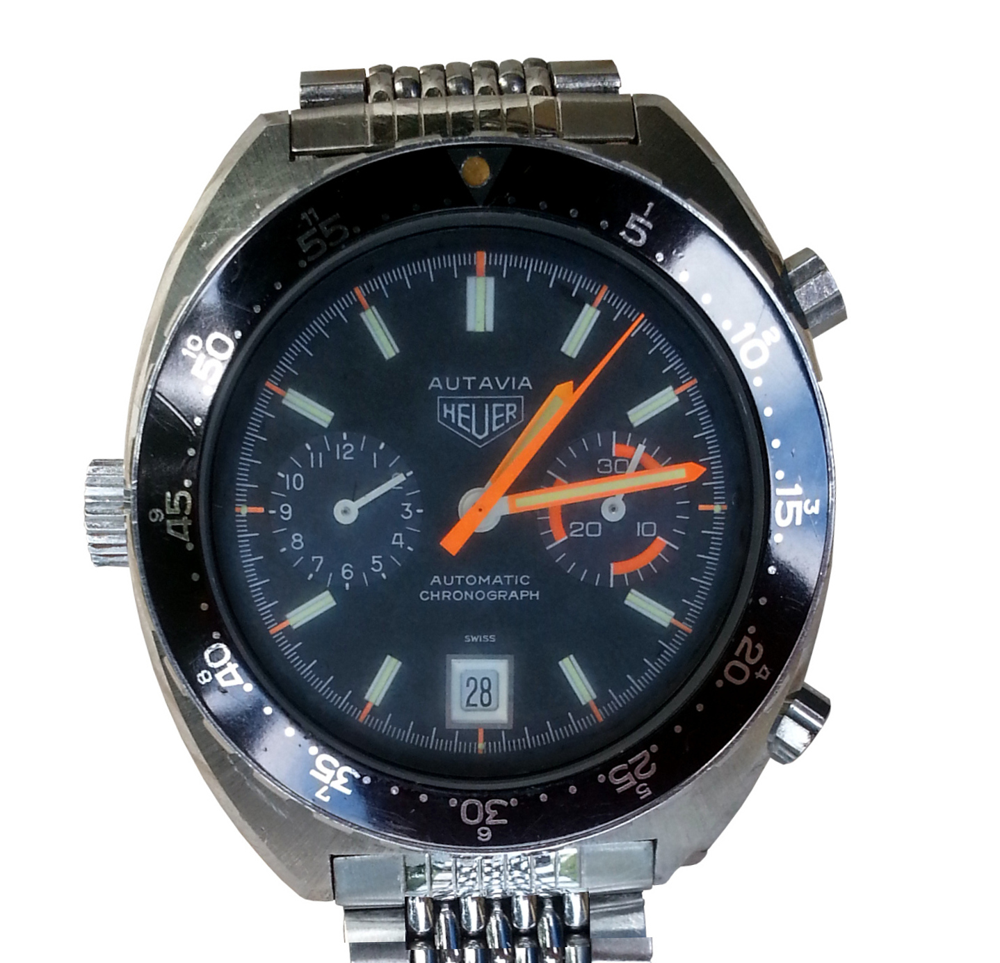 A vintage Heuer Autavia 11630 with a black dial, orange hands and the winding crown on the left side