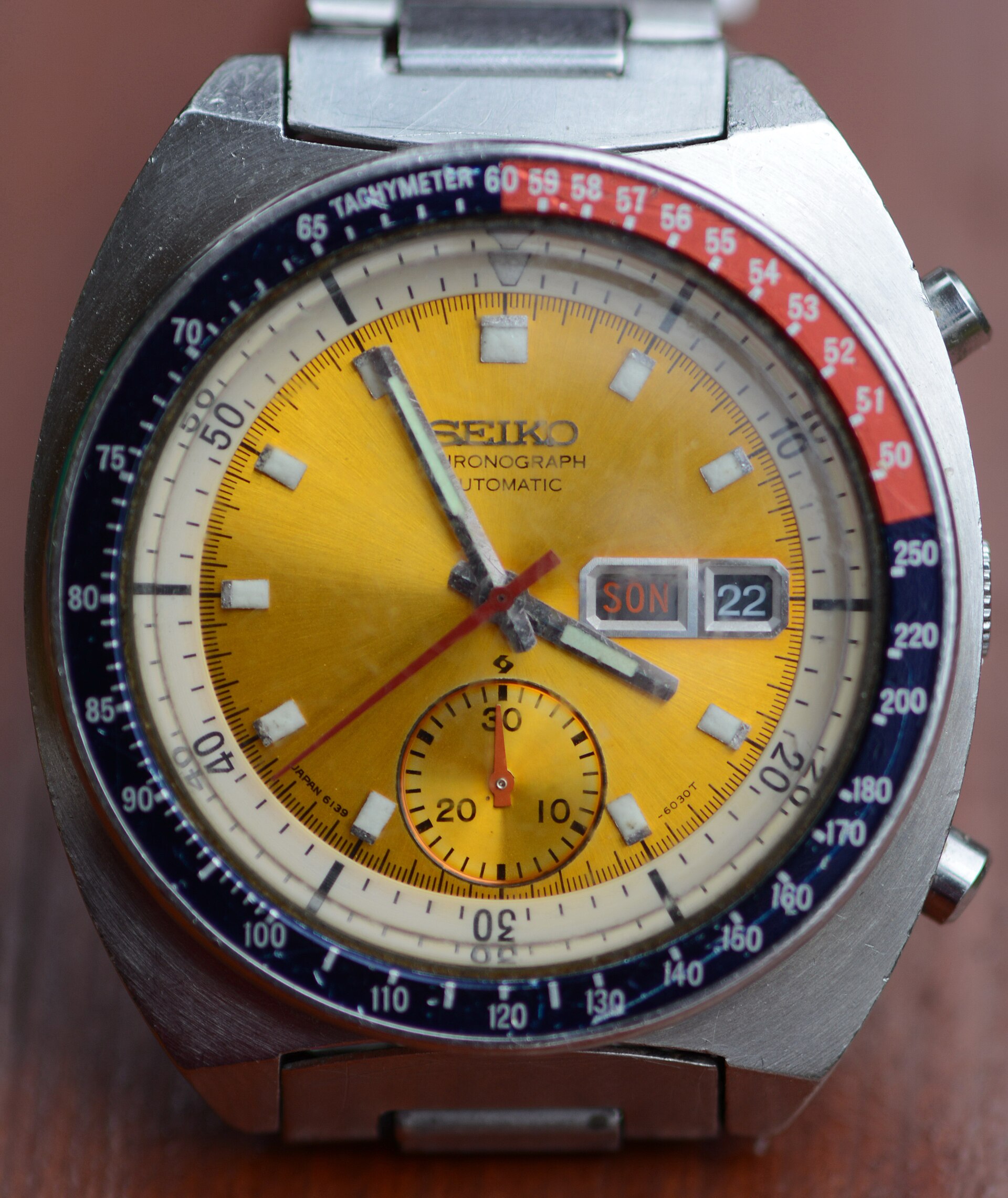 A Seiko 6139 automatic chronograph with a yellow dial and blue and red Pepsi bezel