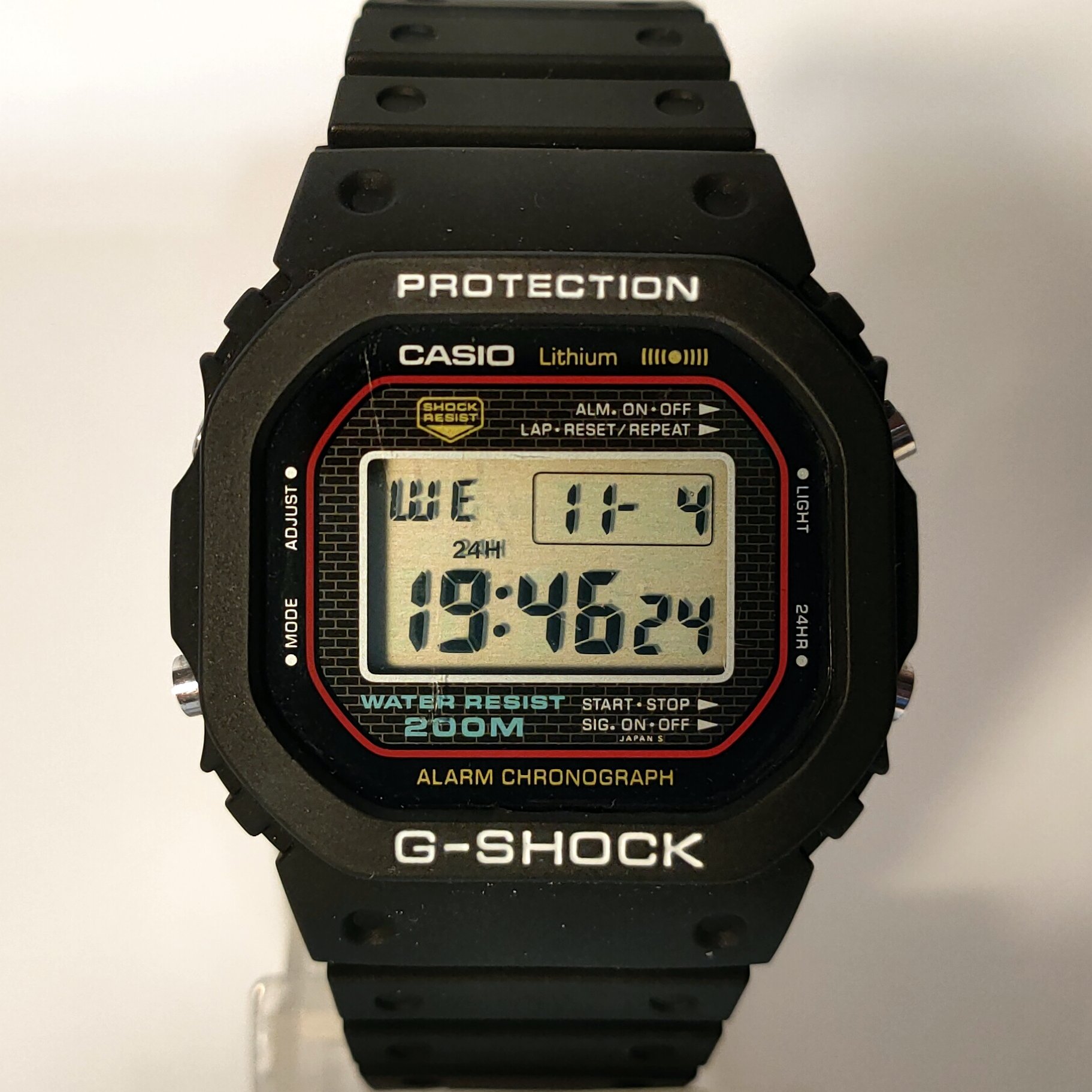 An original 1983 Casio G-Shock DW-5000C square with black resin case and red accents