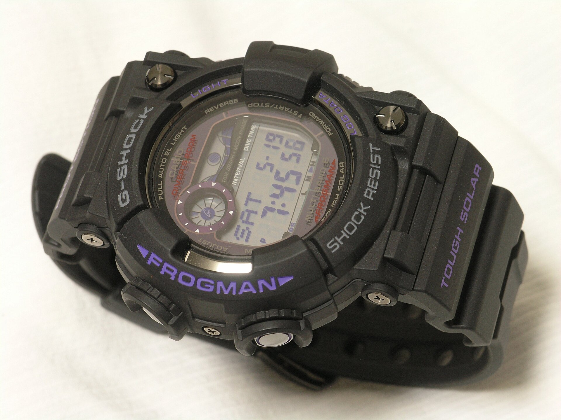 A black G-Shock Frogman GWF-1000 with purple lettering lying on its side