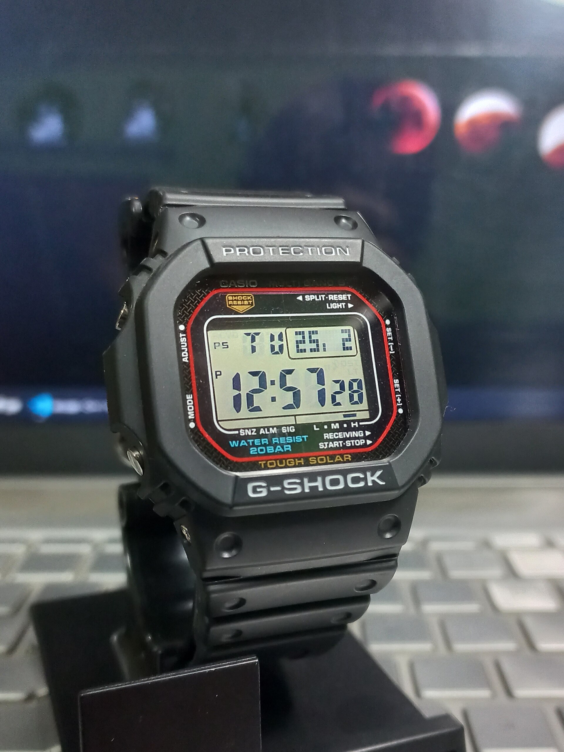 A black Casio G-Shock GW-M5610 solar square standing on a display base