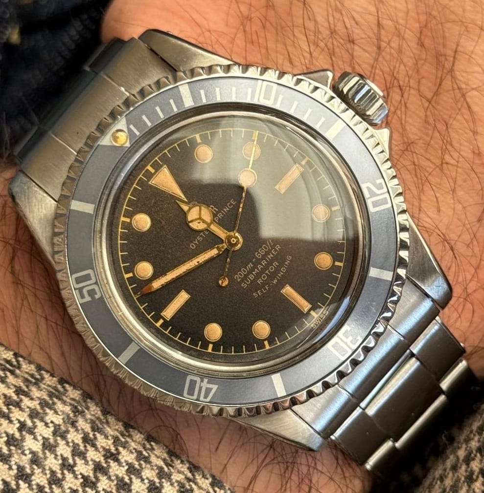 A vintage Tudor Oyster Prince Submariner with gilt dial print and a faded blue-grey bezel on a wrist