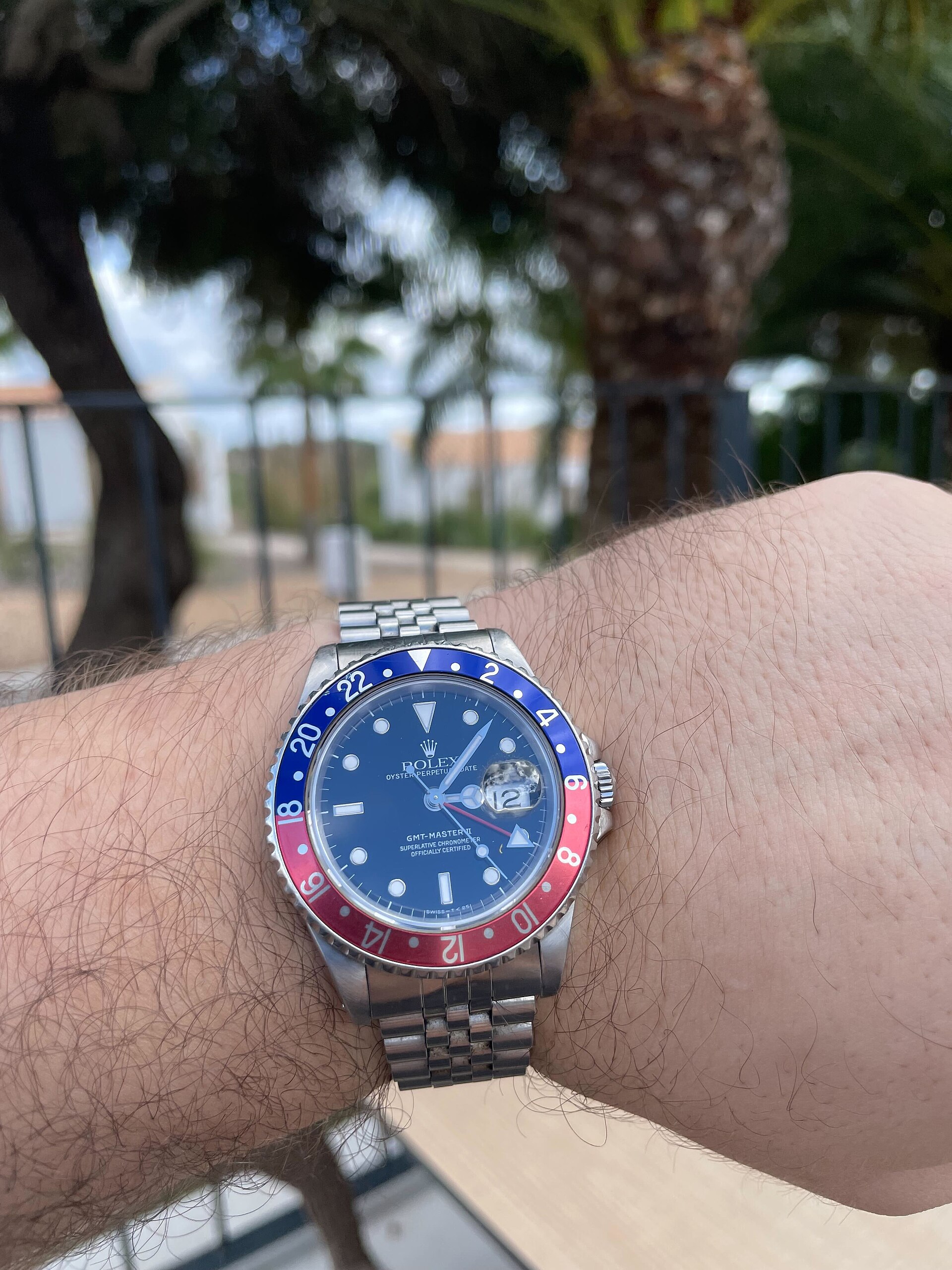 A Rolex GMT-Master II 16710 with a Pepsi bezel and Jubilee bracelet worn on a wrist outdoors