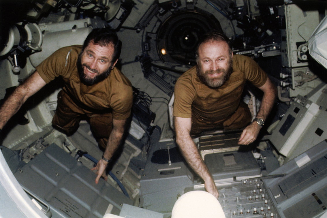 William Pogue and Gerald Carr, both bearded, floating inside the Skylab space station