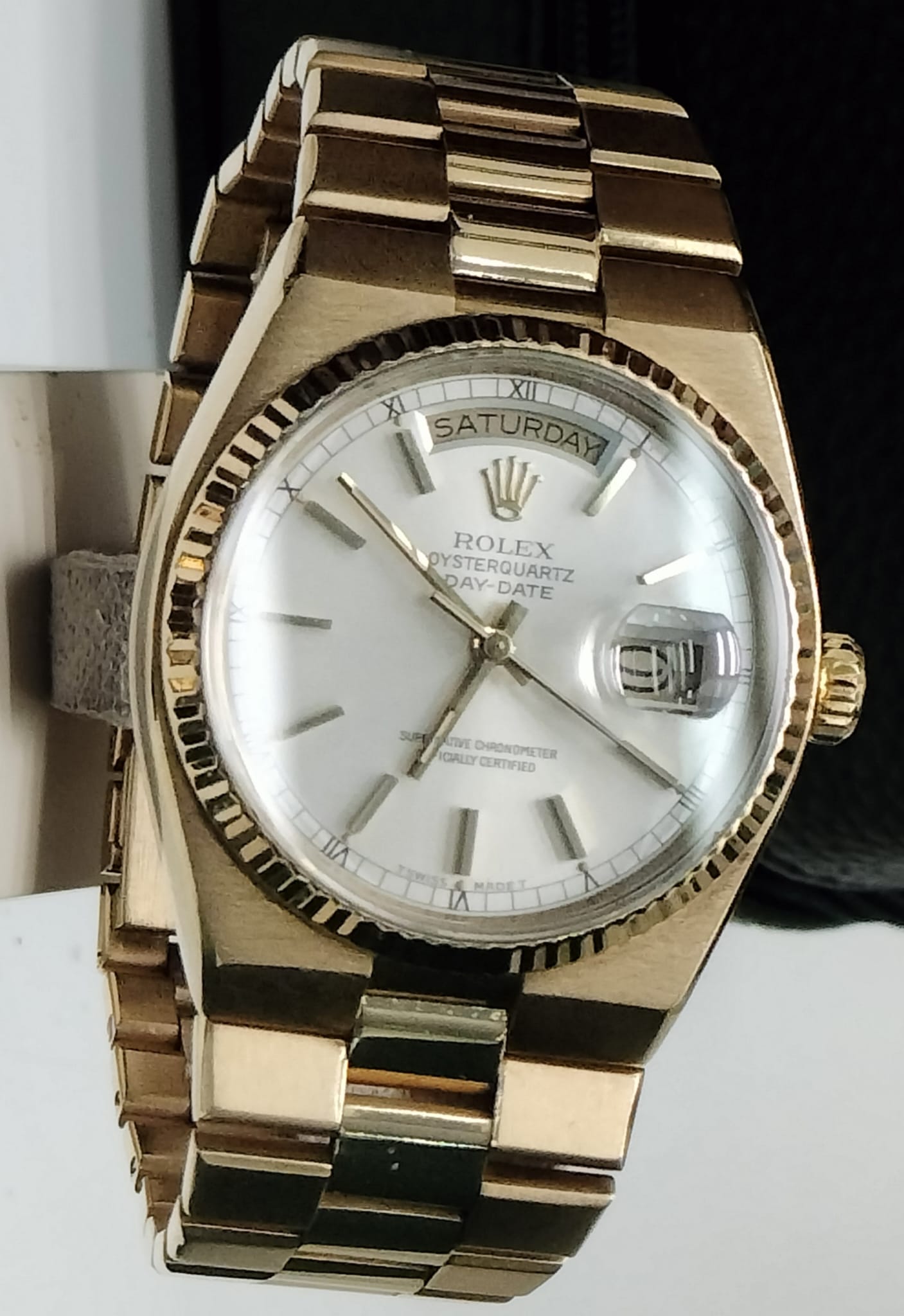 A yellow-gold Rolex Oysterquartz Day-Date with a white dial and integrated President bracelet