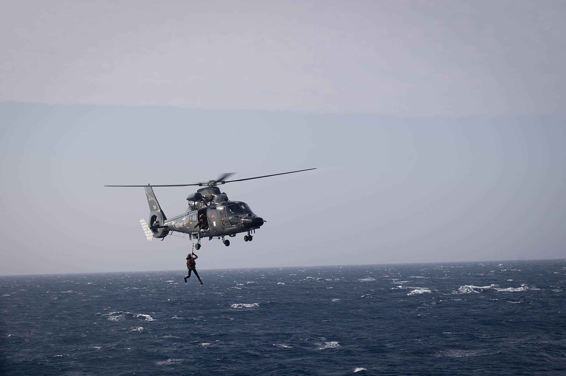 " MEDITERRANEAN SEA - MEDITERRANEAN SEA (Feb. 15, 2020) – A French diver is lifted into a French Marine Nationale AS365 Dauphin helicopter departing the Arleigh Burke-class guided-missile destroyer USS Ross (DDG 71), Feb. 15, 2020. Ross is providing multi-warfare defense support to Charles de Gaulle carrier strike group in the Eastern Mediterranean Sea conducting operations in support of Operation Inherent Resolve. Ross, forward-deployed to Rota, Spain, is on its ninth patrol in the U.S. 6th Fleet area of operations in support of U.S. national security interests in Europe and Africa. "