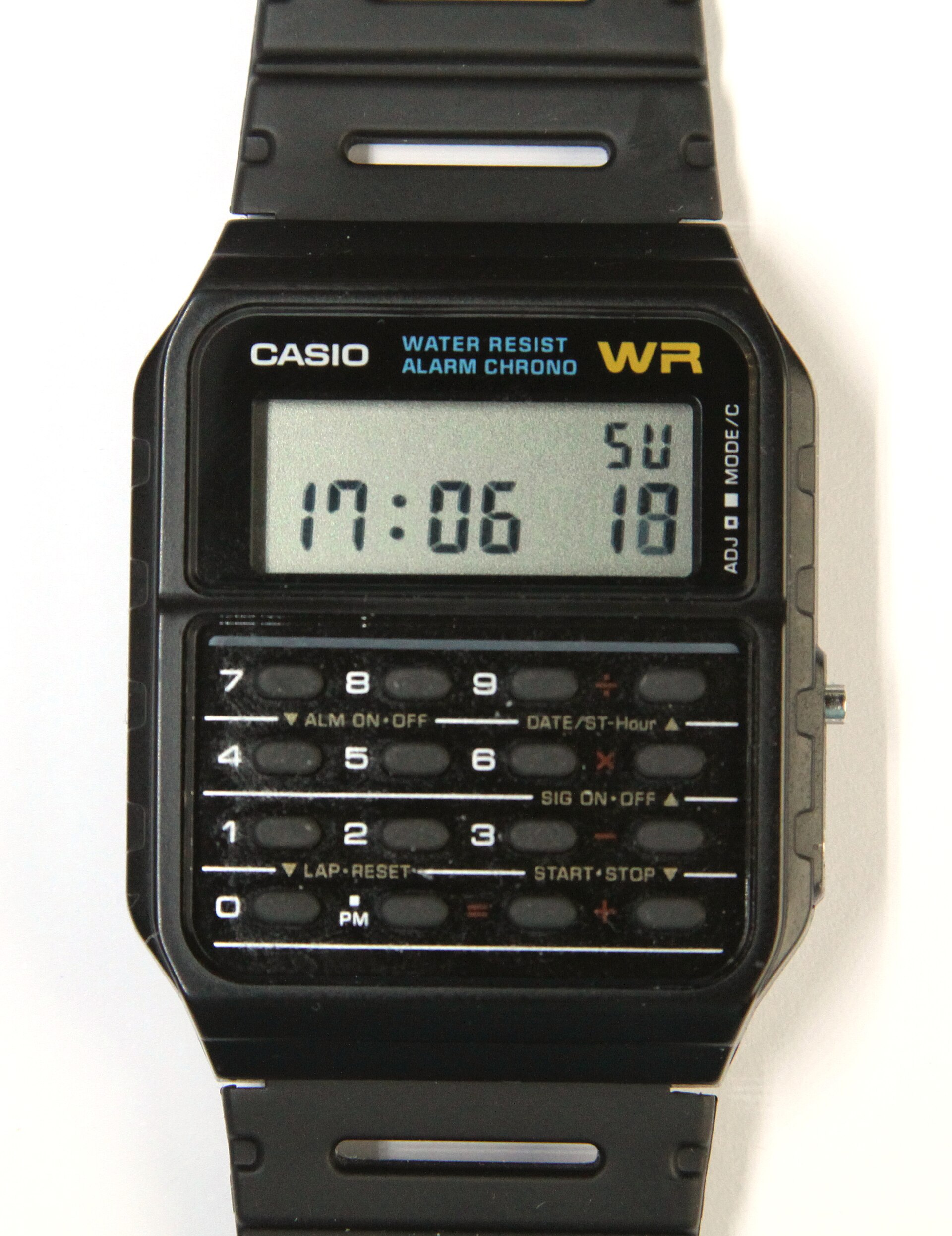 A black Casio CA-53W calculator watch with a number keypad below the display