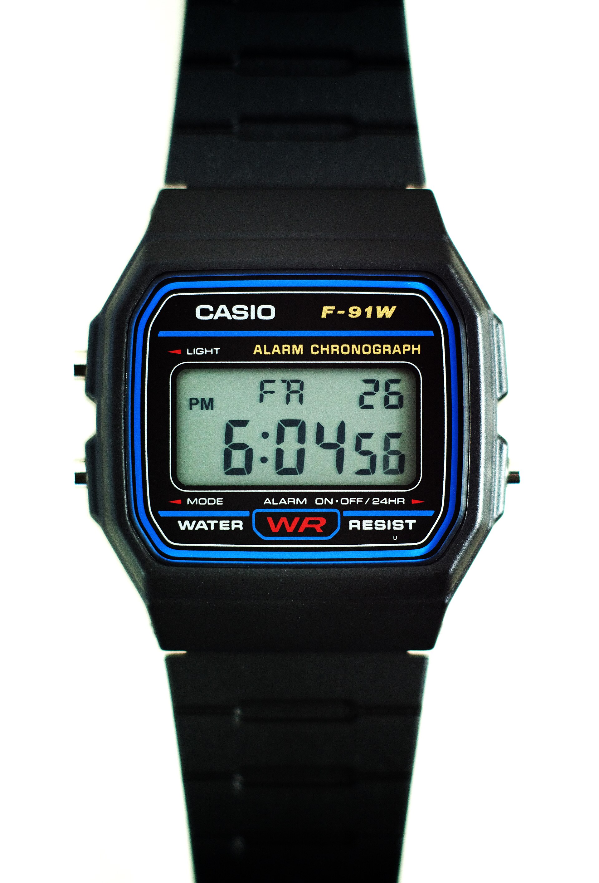 A black Casio F-91W digital watch with a blue-trimmed display